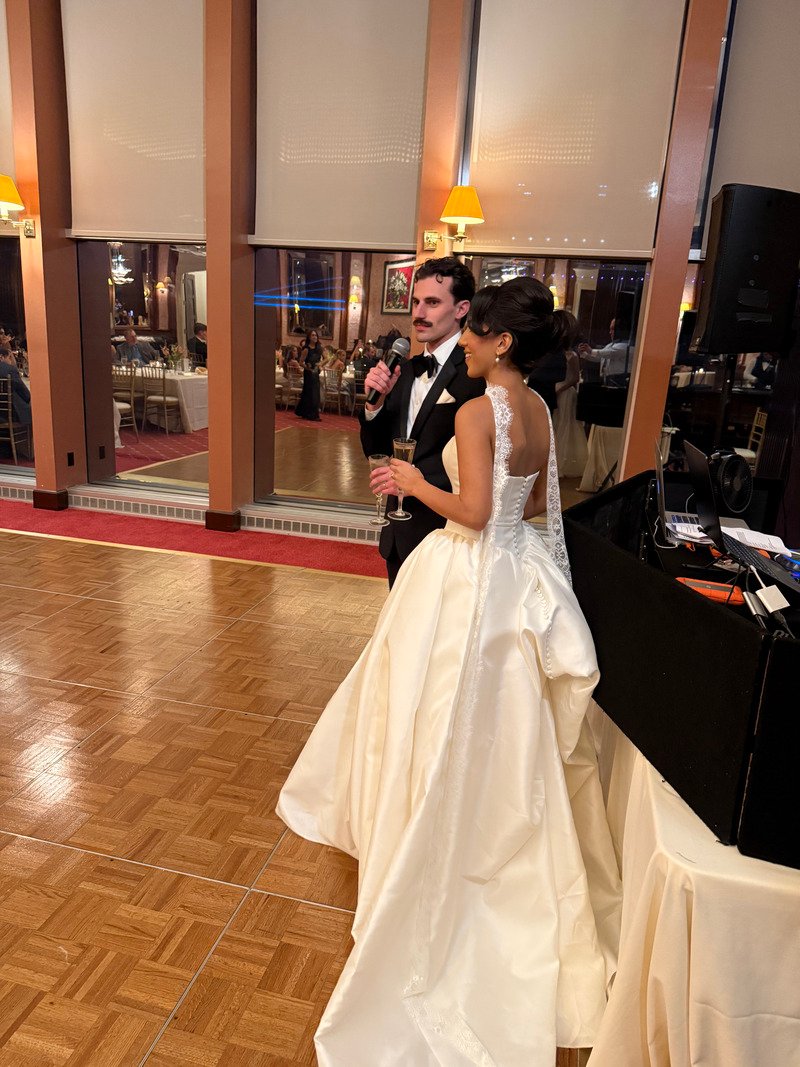 bride and groom on the dance floor giving a speech