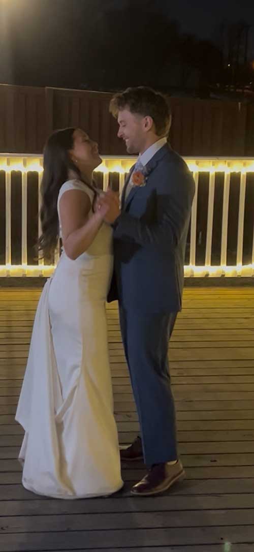 Latino bride and groom dancing with family and guests at an elegant Dallas-Fort Worth wedding reception