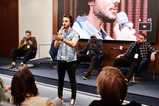 man delivering onstage keynote address
