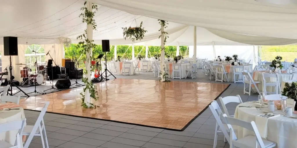 Parquet dance floor installed under a tented wedding reception