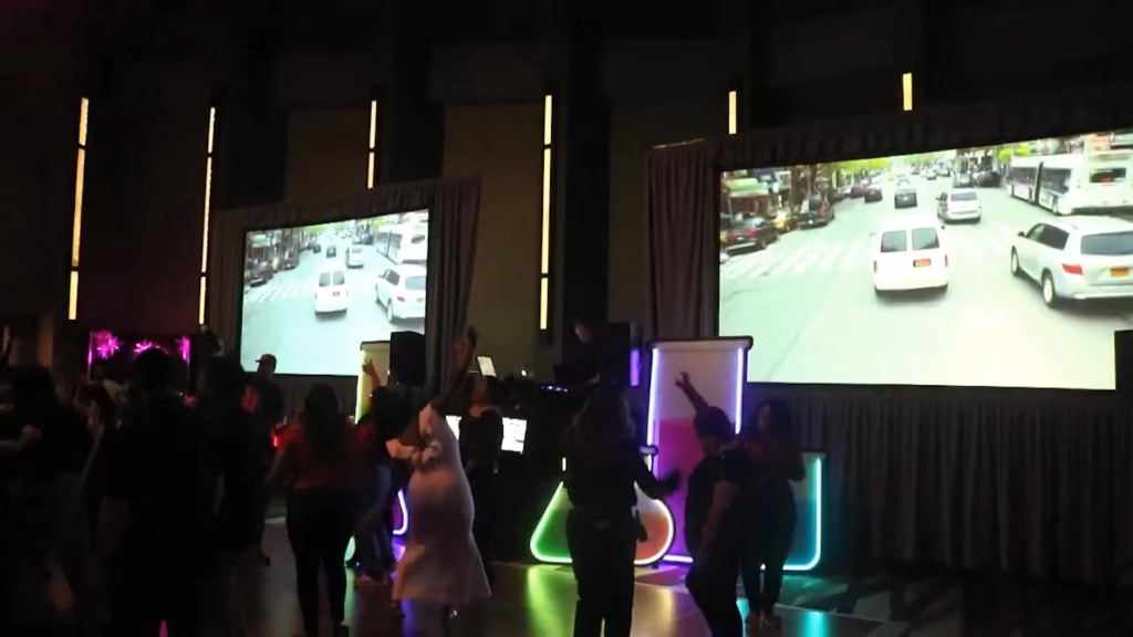 Guests dancing in front of the video screens during a live Groovy Sound set
